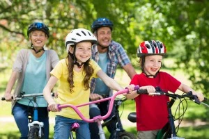 Happy family riding bicycles together in the spring.
