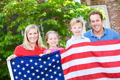 family holding american flag