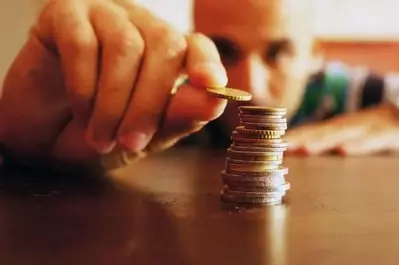 Man counting coins on table