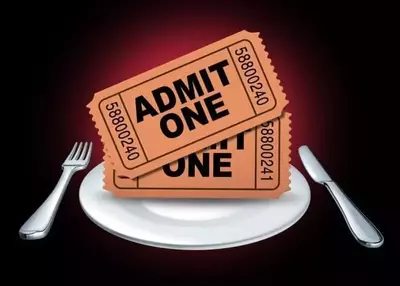 Two "Admit One" tickets on white dinner plate